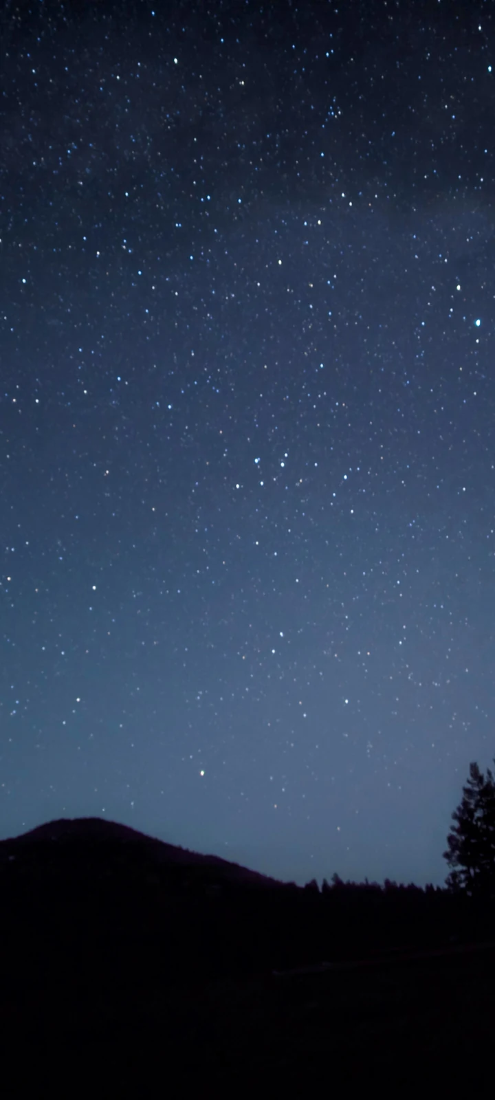 Mountain Arc night-sky photograph prepared as a tall phone wallpaper